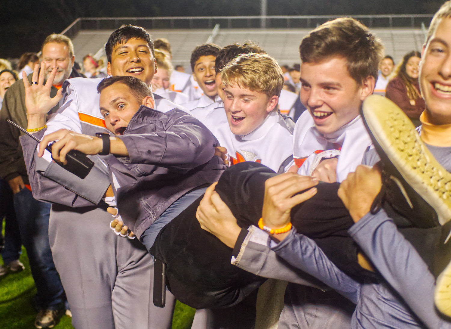 Student teacher Kyle Bennett gets carried away with celebrations by Mineola band students, from left, Jon Esquivel, Brian Bethel, Alex Castillo, Caden Moser Saturday in Carthage.
